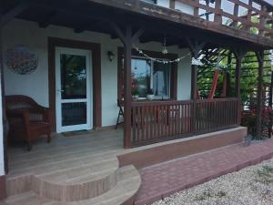 a front porch of a house with a wooden deck at Porto Lima in Limanu