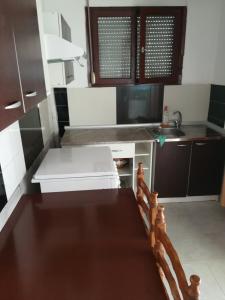 a small kitchen with a stove and a sink at White Coral in Paralia Katerinis