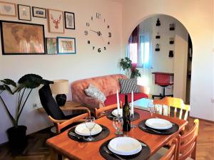 a living room with a table and a couch at Apartment Agava Istria - family vacation rental with free parking, garden, WiFi in Ližnjan