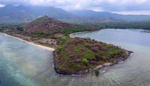 an island in the middle of a body of water at TEGAL SARI, Pemuteran- North Bali in Pemuteran