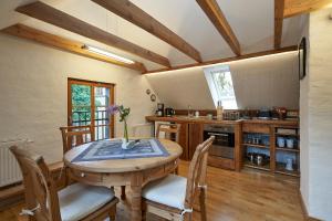 a kitchen with a table and chairs in a room at Heuboden in Mellenthin