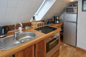 a kitchen with a sink and a stainless steel refrigerator at Heuboden in Mellenthin