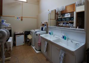 a bathroom with two sinks and a washing machine at Villa Kyoto Saiin in Kyoto