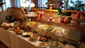 a buffet table with many plates of food on it at Hotel Hotwagner in Maria Enzersdorf