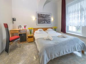 Postel nebo postele na pokoji v ubytování Murena Hotel i Restauracja