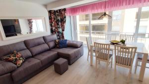 a living room with a couch and a table at Carmen apartments with sea view near Alicante in Santa Pola