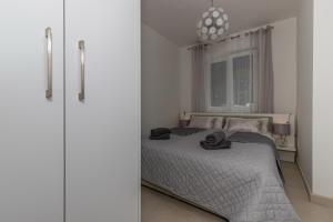 Posteľ alebo postele v izbe v ubytovaní Apartmani Kecman