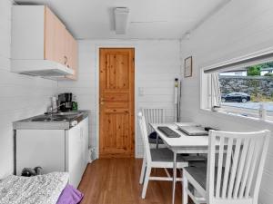 a kitchen and dining room with a table and a desk at Grimen Camping in Bergen