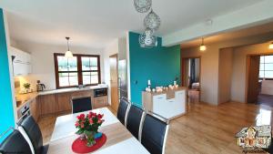 a kitchen and dining room with a table and chairs at Agrosielanka in Lipnica