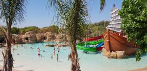 a group of people in a pool at a water park at Hotel Clipper - EL DELFÍN VERDE RESORTS - Platja de Pals in Torroella de Montgrí