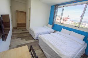 Postel nebo postele na pokoji v ubytování Fantasy Homestay
