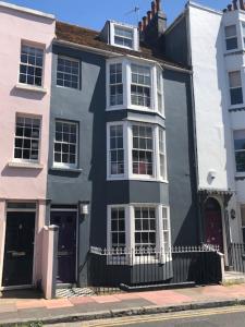 a blue and white house on the side of a street at Parisien Parfumerie in Brighton & Hove
