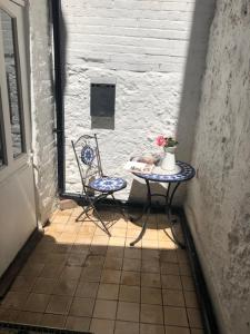 a table and a chair sitting in a doorway at Parisien Parfumerie in Brighton & Hove