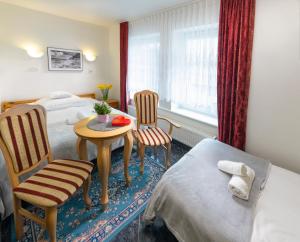 Postel nebo postele na pokoji v ubytování Murena Hotel i Restauracja