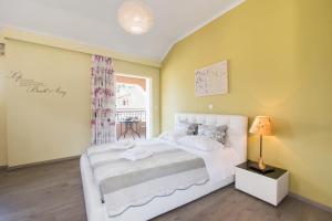 a bedroom with a white bed and a window at Kadith Apartments in Agios Gordios