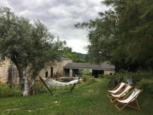 two lawn chairs and a hammock in a yard at Acquavilla in Pombal