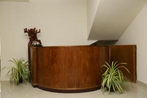 a wooden partition with two plants in a room at Le Noor in Ernakulam