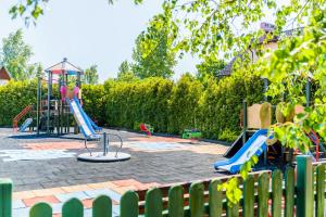 a playground with two slides and a play structure at Apartament u Andzi in Stegna