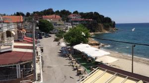 a beach with a bunch of umbrellas and the ocean at Emy Studios in Fanárion