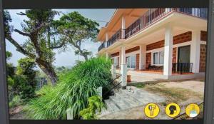 a house with a staircase leading to the front of it at Forestdale Coorg in Virajpet