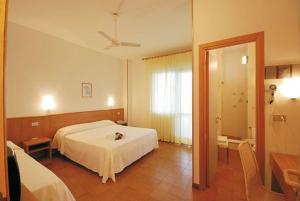 Postel nebo postele na pokoji v ubytování Hotel Leuco'
