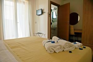 Postel nebo postele na pokoji v ubytování Hotel Leuco'