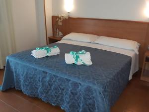 Postel nebo postele na pokoji v ubytování Hotel Leuco'