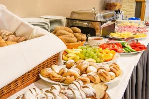 a buffet filled with different types of bread and pastries at Sport Apartmán DM in Dolní Morava +30 photos