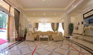 a large living room with a large couch and chairs at ARK BILLUR HALAL Hotel in Tashkent