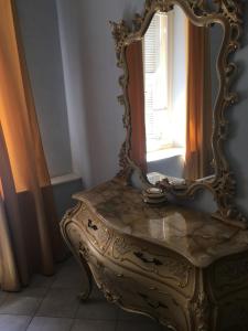 an ornate mirror sitting on a table next to a window at Hotel Sanremo in Sanremo +47 photos