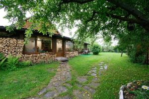 a house with a yard in front of it at Pensiunea Casa Bianca - Bucovina in Vama
