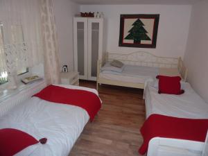a bedroom with two beds and a christmas tree on the wall at KOWALÓWKA in Mirsk
