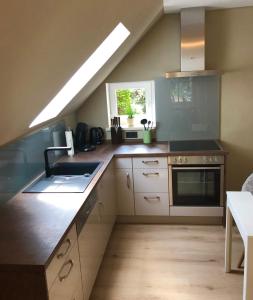 a kitchen with a sink and a stove top oven at Paradiesje in Leer