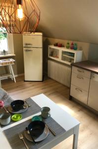 a kitchen with a table with pots and pans on it at Paradiesje in Leer