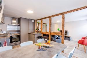 a kitchen and dining room with a table and chairs at #CMI - CENTRE HISTORIQUE - Wifi - Tout confort in Colmar