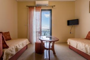 a room with a table and a window with a view at Hotel Villa Nisteri in Limenas
