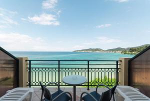 a balcony with chairs and a table and the ocean at Hotel Villa Nisteri in Limenas