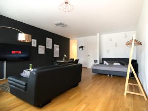 a living room with a couch and a bed at NEW STUDIO@Baroque City Center in Dresden