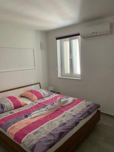 a bedroom with two beds and a window at Apartmani Danica in Nerezine