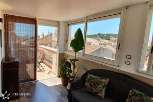 a living room with a couch and a large window at StellaHome - Sur Les Toits in Sanary-sur-Mer