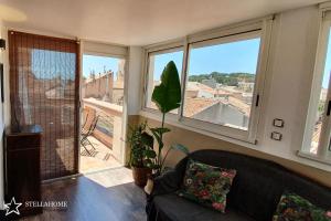 a living room with a couch and a large window at StellaHome - Sur Les Toits in Sanary-sur-Mer +8 photos