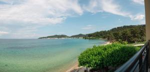 a view of a beach from a balcony at Hotel Villa Nisteri in Limenas