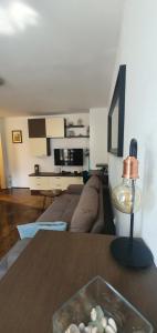a living room with a couch and a table at Apartment Terra in Mali Lošinj +14 photos