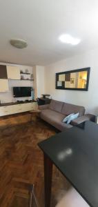 a living room with a couch and a table at Apartment Terra in Mali Lošinj
