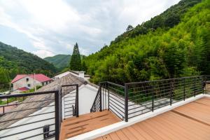 a balcony with a view of a mountain at In Flower Hotel in Deqing