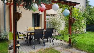 a patio with a table and chairs under a pergola at Studio Ania in Stegna