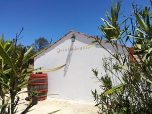 a white house with a sign on the side of it at Quinta Bogesi in Figueira da Foz