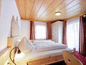 Letto o letti in una camera di Sagritzerwirt