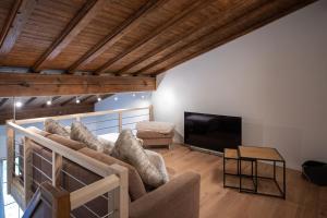 a living room with a couch and a flat screen tv at Chalet Laret in Davos