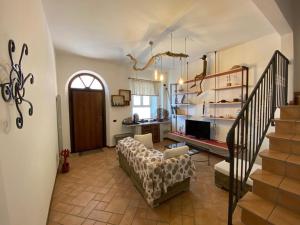 a living room with a couch and a staircase at Camere Frangimare in Porto Recanati